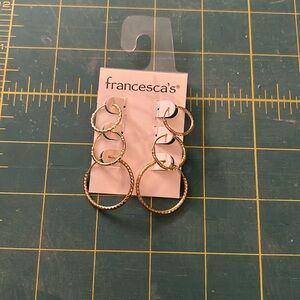 3 sets of gold hoop earrings.